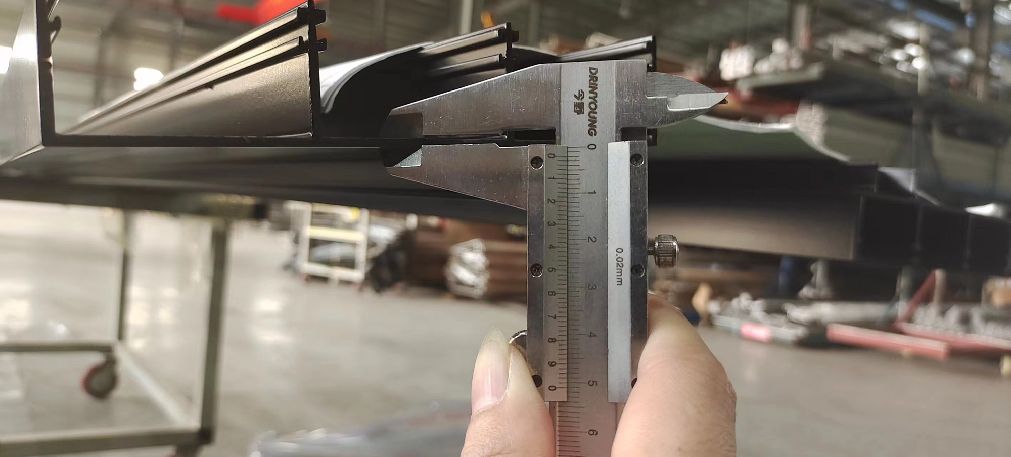 Checking aluminium profile dimensions with calipers